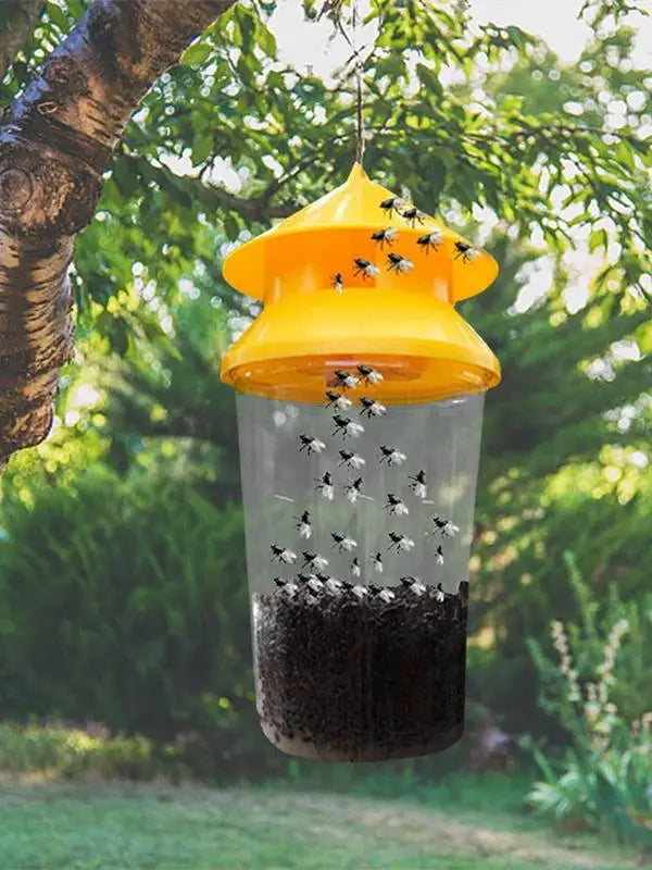 Belro reusable outdoor hanging fly trap hanging from a tree branch in a garden for effective pest control.