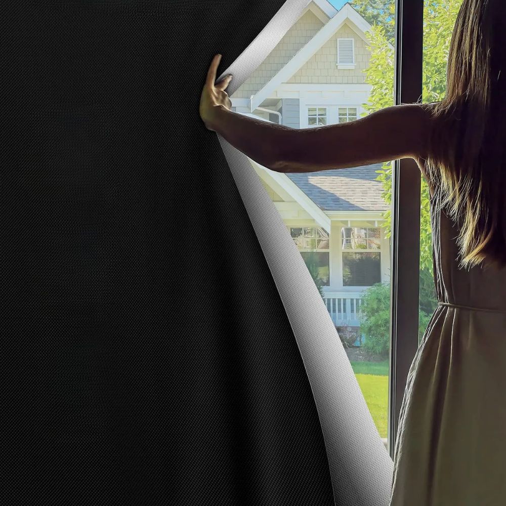 Blackout black adhesive sun blocking window shade from Belro, designed for men to block sunlight and improve privacy.