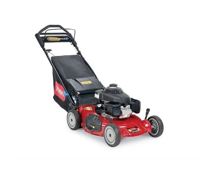Toro 21-inch Super Recycler mower with Casavibeo branding, showing the cutting deck and grass collection bag in a yard setting.