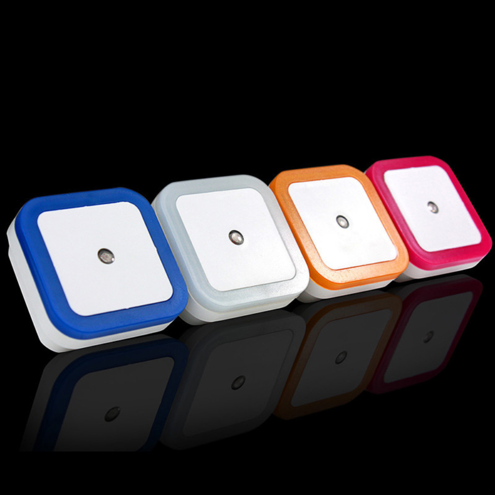 Belro plug-in motion detector smart outlet night light connected to an electrical socket, showing its compact design and sensor.