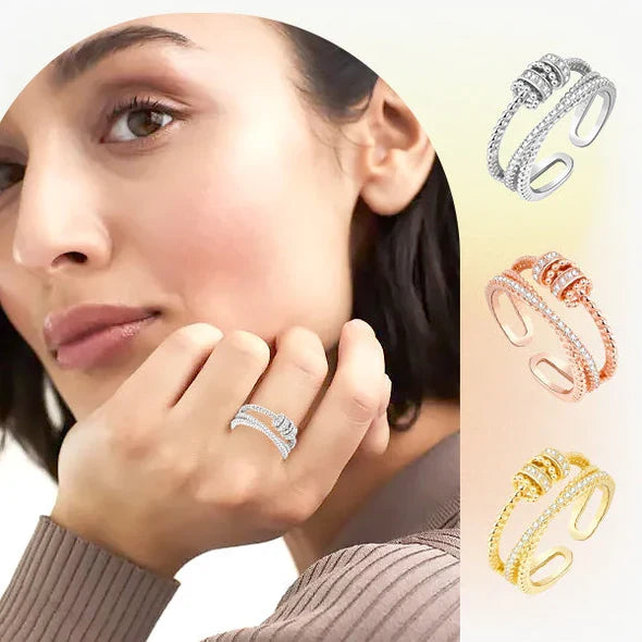 Belro Threanic Triple-Spin Ring showcasing a sleek, multi-band jewelry ring with spinning elements on a plain background.