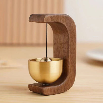 Wireless door chime with brass bell and wooden frame from Belro, designed for smart home doorbell systems.