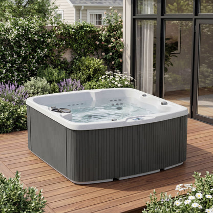 Casavibeo Lifesmart Leganza 6-person spa with 90 jets, lounge seating, in coastal gray, angled view of the outdoor hot tub.