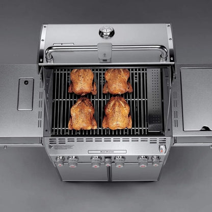 Casavibeo Weber Summit S-470 gas grill with stainless steel lid and multiple burners, outdoor cooking with side shelves and control panel.