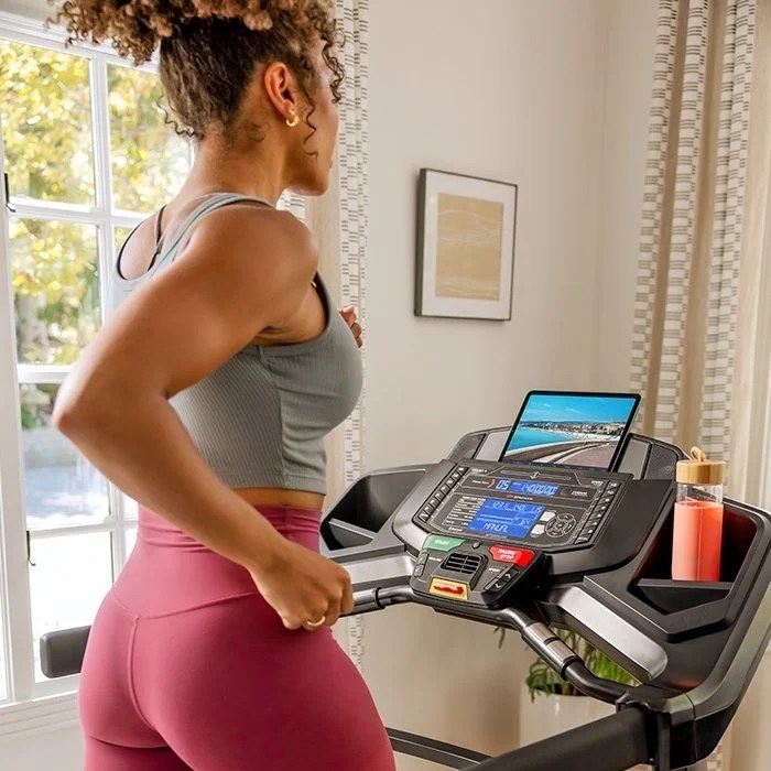Casavibeo Bowflex BXT8J treadmill with digital display, running belt, and adjustable handrails in a home gym setting.