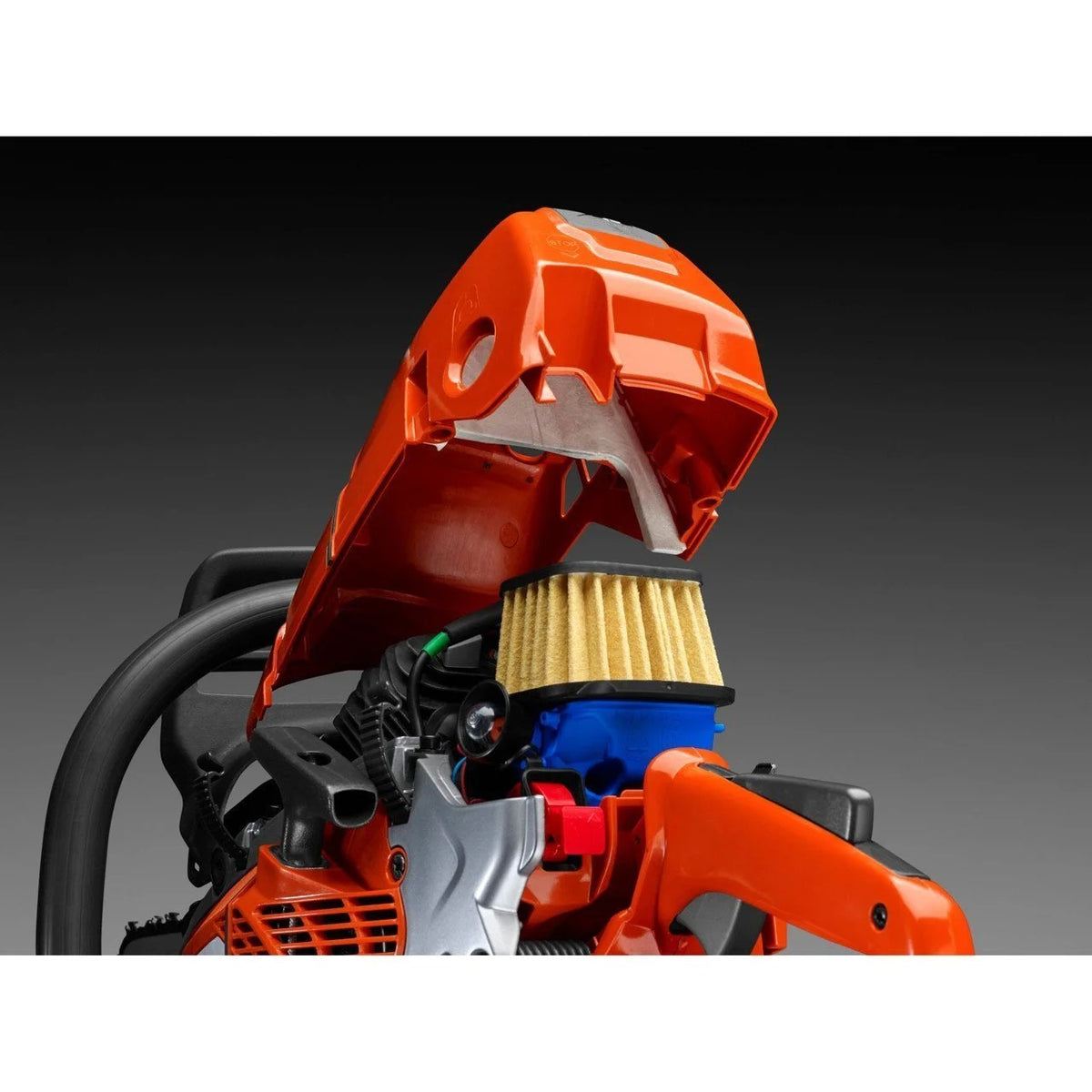 Husqvarna 572XP chainsaw with black and silver body, featuring a long cutting bar and chain, positioned on a workbench.