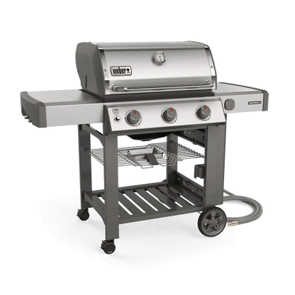 Casavibeo Weber Genesis II S-310 gas grill with stainless steel lid, four burners, and side shelves for outdoor cooking.