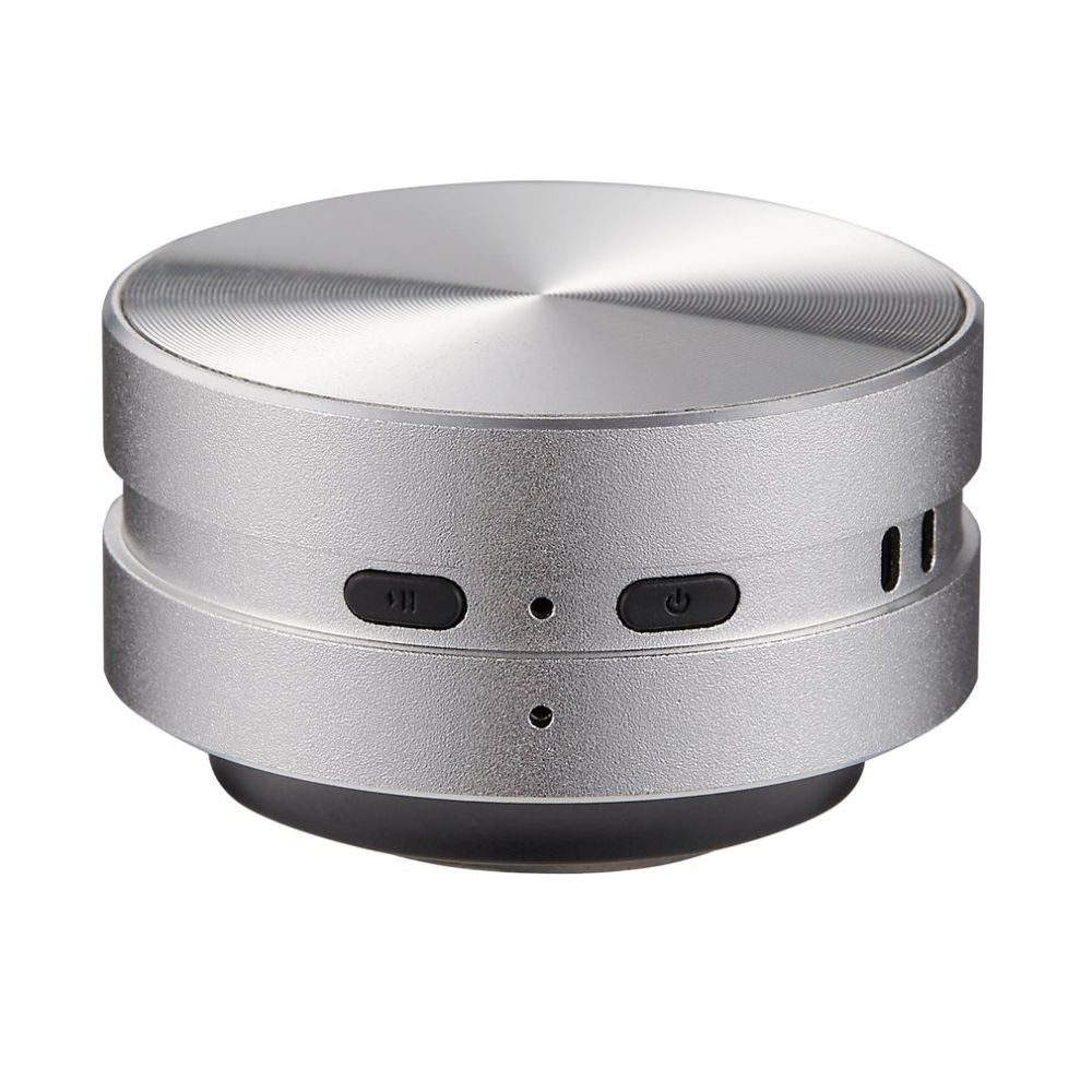 Belro Bone Induction Speaker resting on a surface, showcasing its sleek design and compact size for turning surfaces into audio speakers.