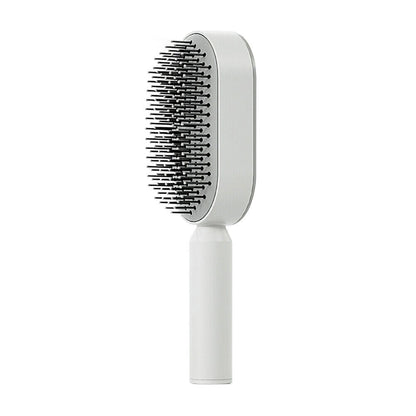 Belro self-cleaning hair brush with ergonomic handle and flexible bristles for easy hair detangling and cleaning.