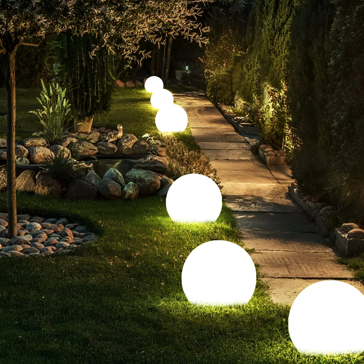 BowLift LumiGlobe weatherproof solar LED garden light shining outdoors, ideal for illuminating pathways and garden spaces.