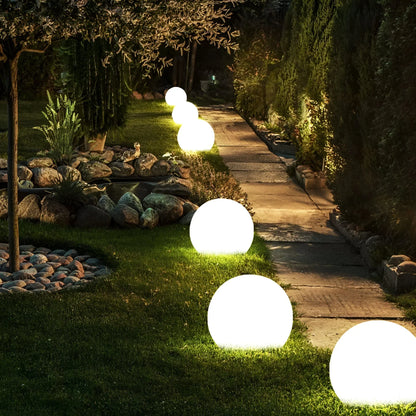 BowLift LumiGlobe weatherproof solar LED garden light shining outdoors, ideal for illuminating pathways and garden spaces.