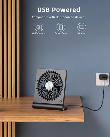Belro Ultra Quiet Small Desk Fan on a desk, compact electronic home appliance with adjustable blades for cooling.