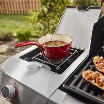 Casavibeo Genesis II E-335 gas grill with stainless steel body, multiple burners, and side shelves for outdoor cooking.