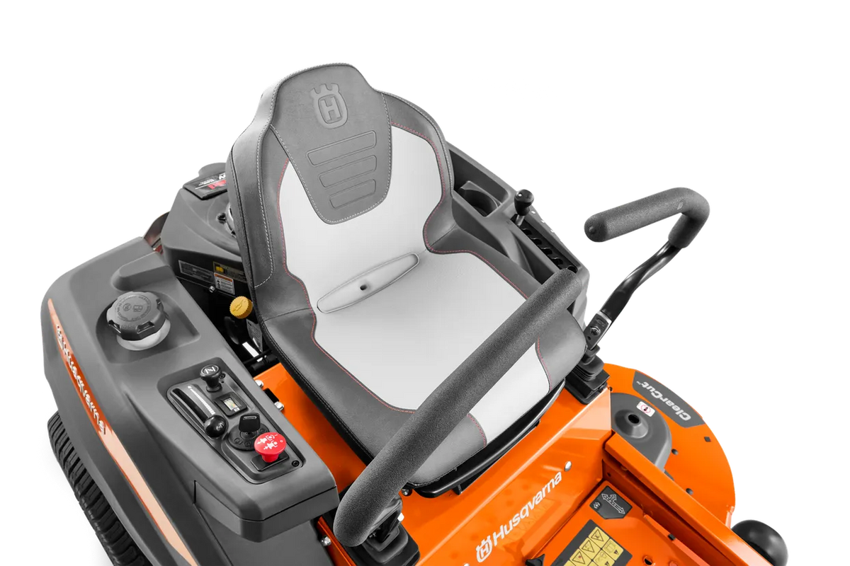 Husqvarna Z254F 54-inch zero-turn riding lawn mower with 24 HP Kawasaki engine, shown in a well-maintained yard.