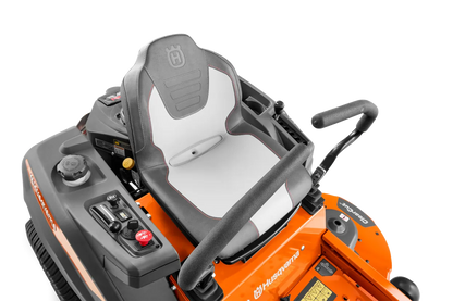 Husqvarna Z254F 54-inch zero-turn riding lawn mower with 24 HP Kawasaki engine, shown in a well-maintained yard.