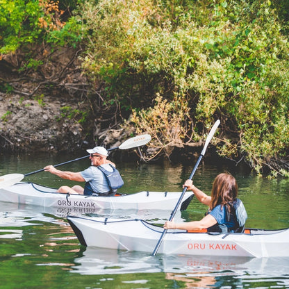 Casavibeo Oru Inlet fold-up single kayak on water, showcasing its compact design and portability for outdoor boating adventures.