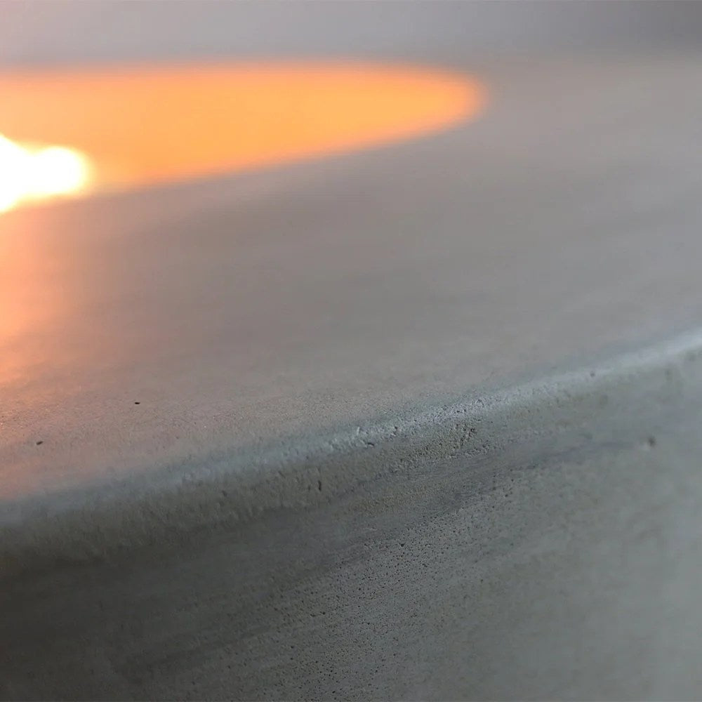 Casavibeo Orren Ellis Lunar Bowl Roca outdoor concrete fire pit with a round, modern design and textured surface for outdoor ambiance.