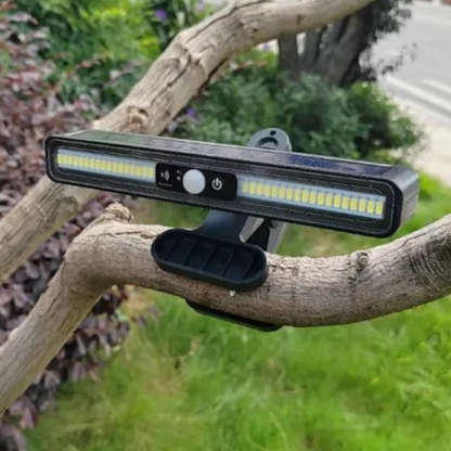 Belro waterproof solar-powered outdoor garden landscape lamp shining in a garden at dusk.