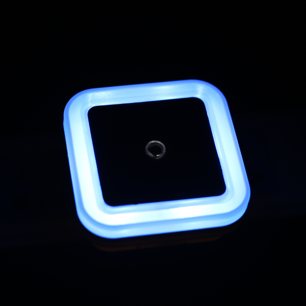 Belro Plug-In Motion Detector Smart Outlet Night Light glowing in a wall socket, featuring motion sensors and compact design.