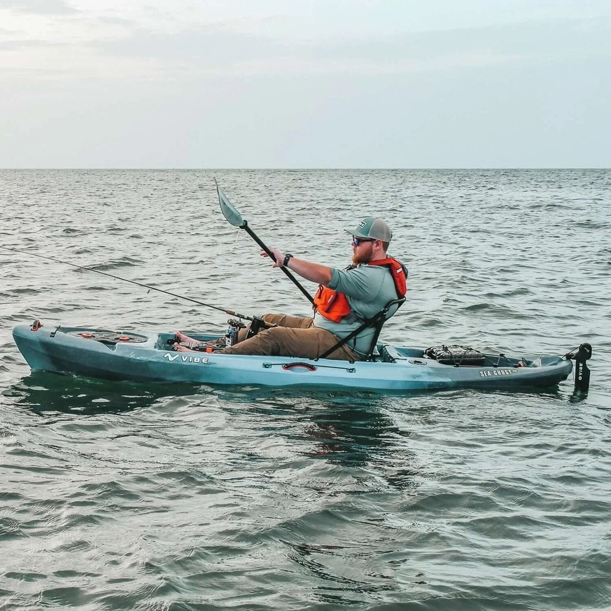 Casavibeo Vibe Kayaks Sea Ghost 110 kayak on water with paddle, showcasing sleek design and vibrant color for outdoor boating.