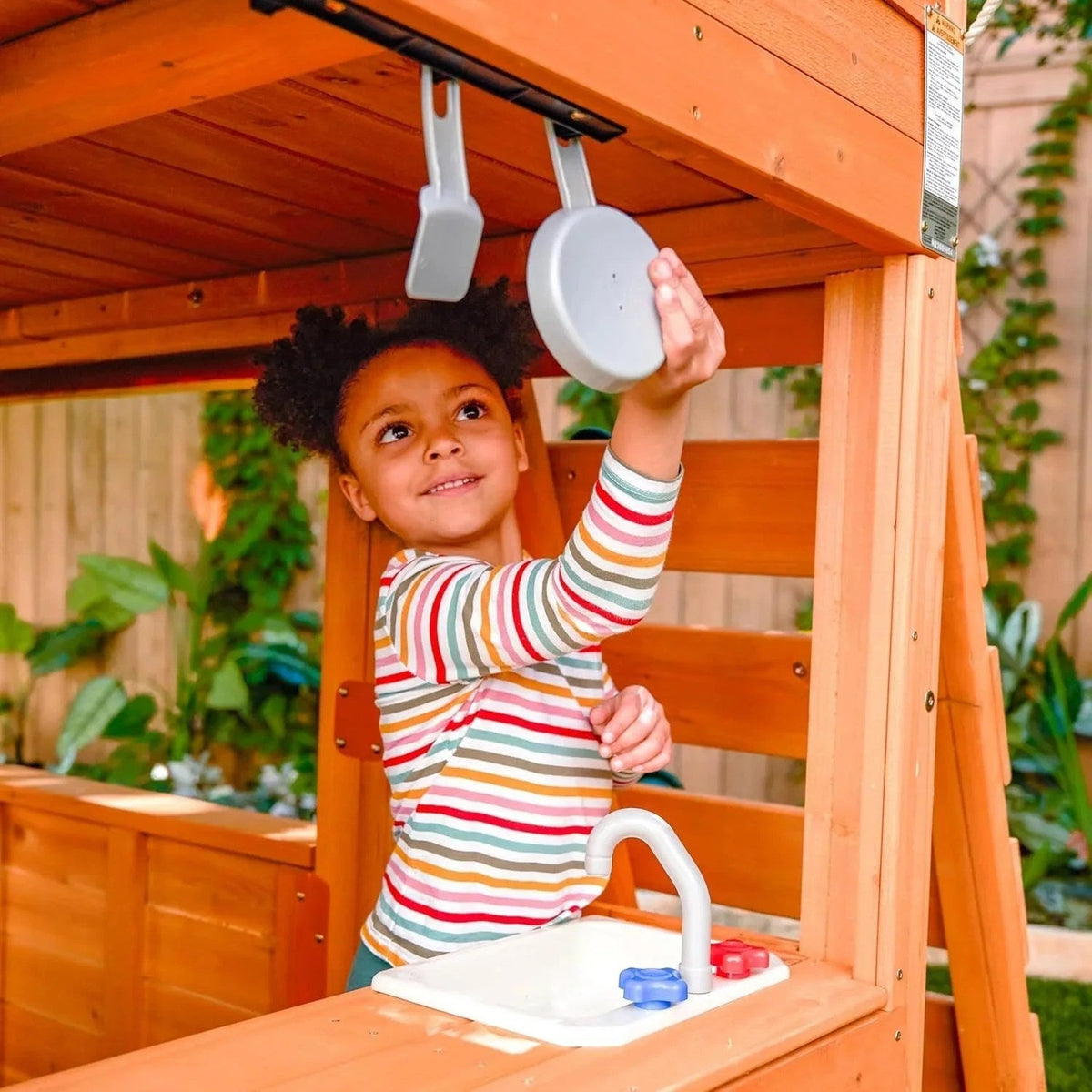 Casavibeo KidKraft Falcon Ridge wooden swing set with slides, swings, and climbing features for children outdoor play.