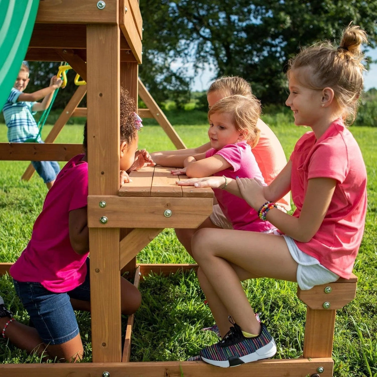 Casavibeo Backyard Discovery Belmont cedar swing set with slides, swings, and climbing features in a backyard setting