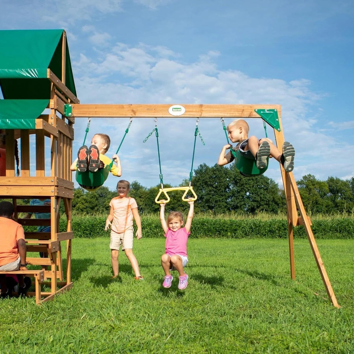 Casavibeo Backyard Discovery Belmont cedar swing set with swings, slide, and climbing features in an outdoor backyard setting.
