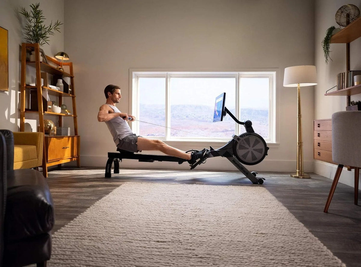 Casavibeo NordicTrack RW900 rowing machine with adjustable seat and digital display, positioned on a workout floor.