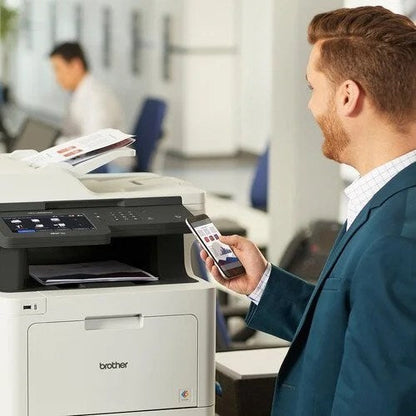 Wireless color laser printer from Brother MFC-L8905CDW with paper tray and control panel, suitable for office use.
