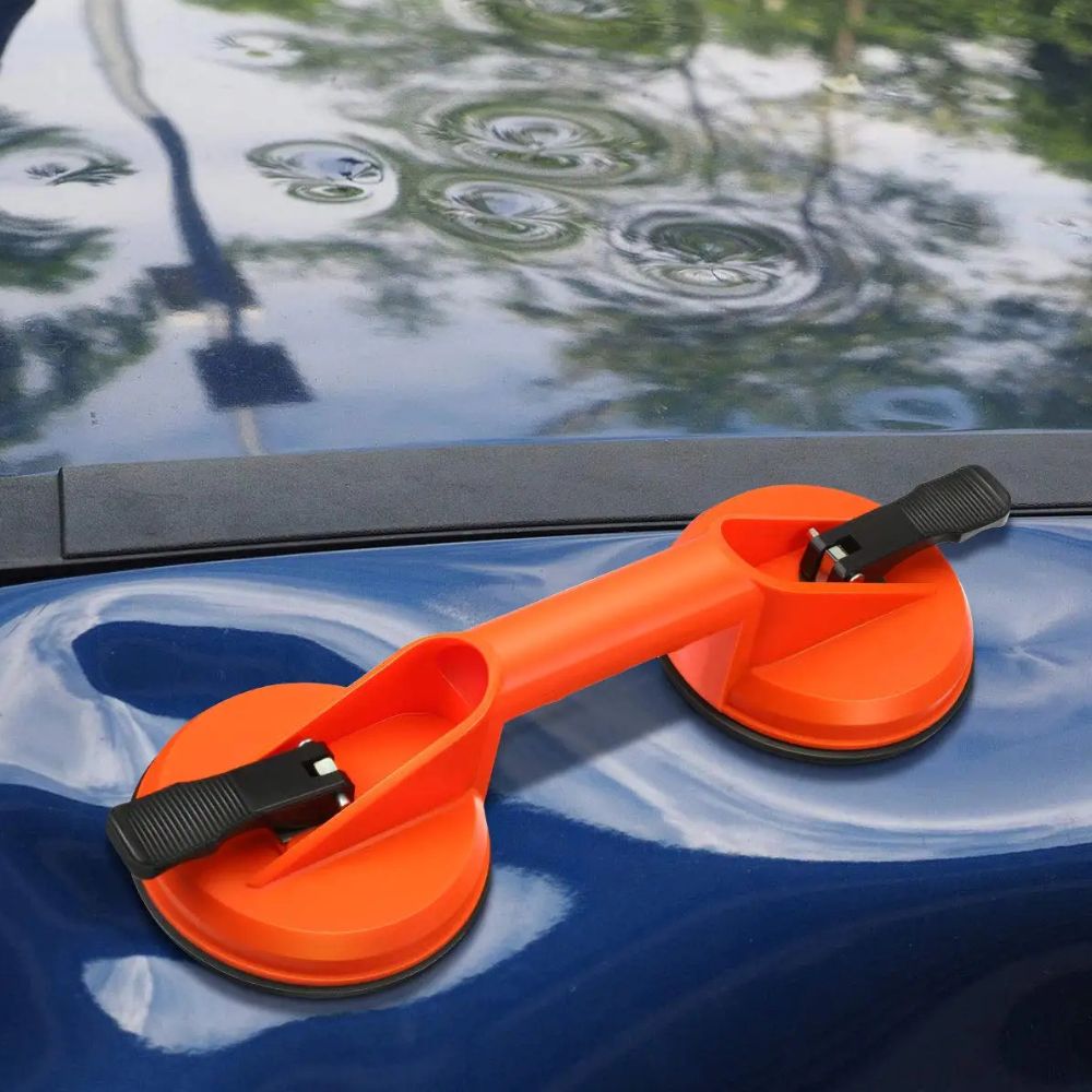 Belro dual suction glass window dent pulling suction cup attached to a window for dent removal.