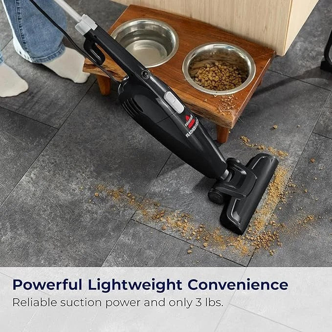 Casavibeo Bissell Featherweight stick vacuum in black with crevice tool, lightweight bagless design for easy cleaning.