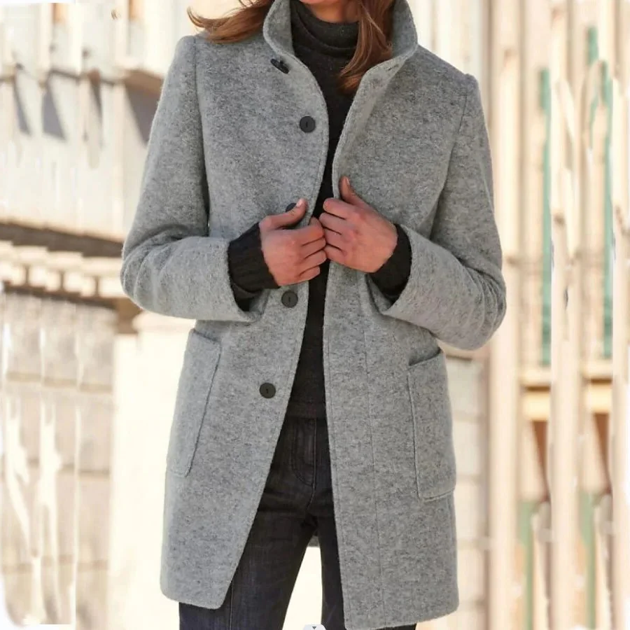 Elegant wool coat from Belro featuring a classic tailored design, shown hanging on a wooden hanger.