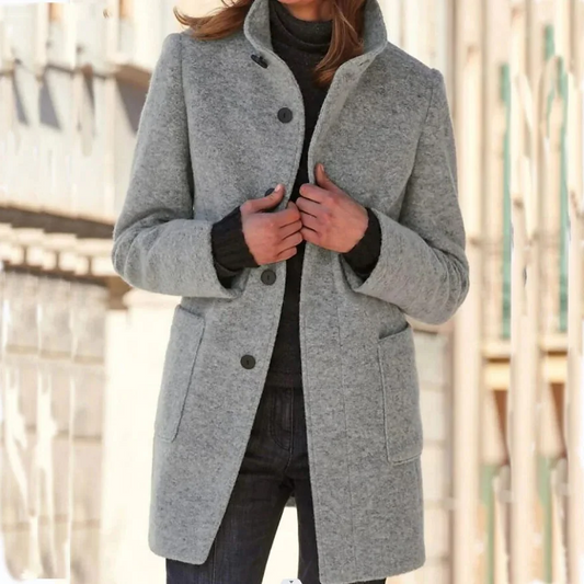 Elegant wool coat from Belro featuring a classic tailored design, shown hanging on a wooden hanger.