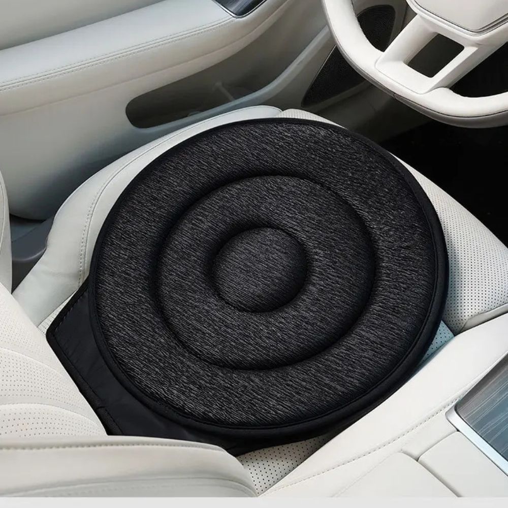 Belro Cozy 360-degree car swivel chair pad shown on a T-shirt, featuring a comfortable, versatile design in a neutral color.