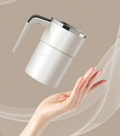 Belro rechargeable mug with built-in stirring mechanism, black ceramic with digital control display, on a wooden table.