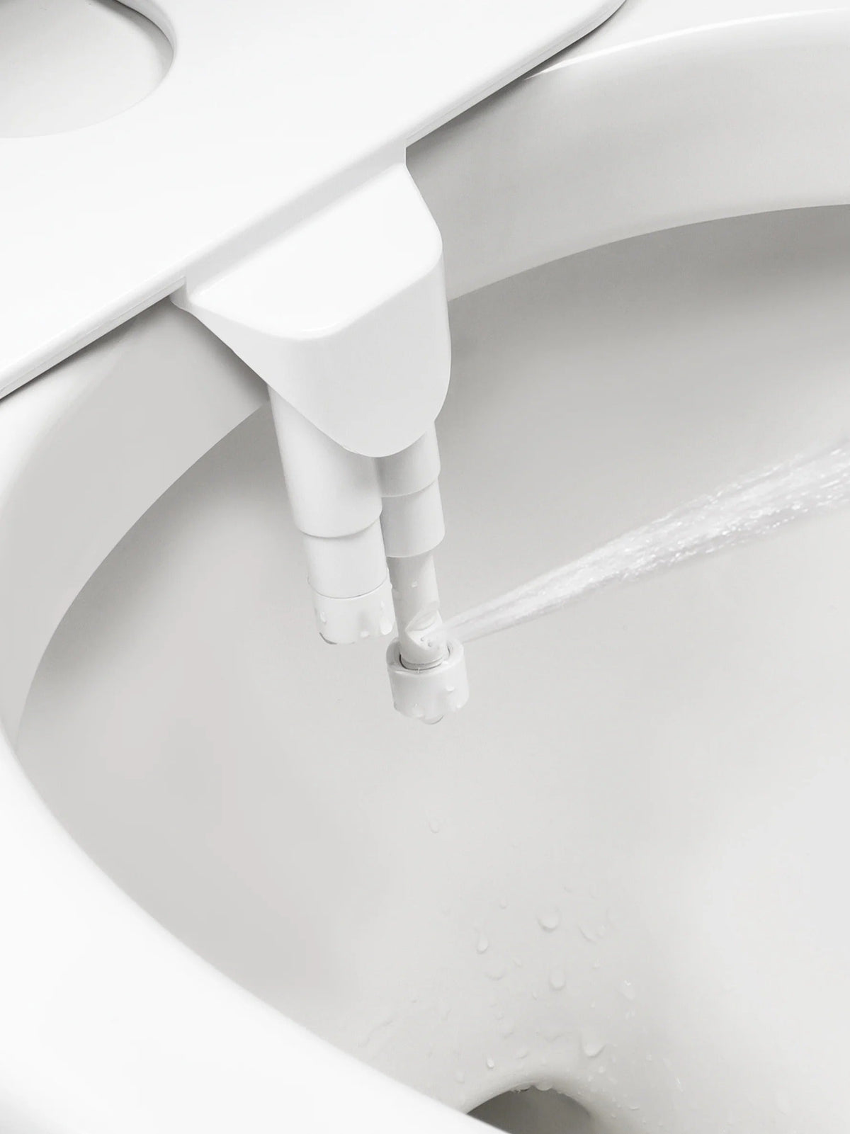 Belro toilet bidet attachment installed on bathroom toilet, showcasing water control nozzle and adjustable features.