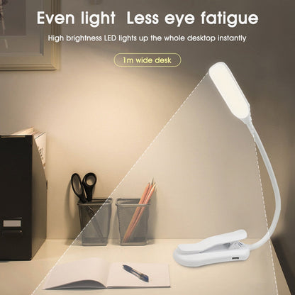 Belro reading lamp clamp attached to a book in an outdoor setting, providing focused lighting for reading outside.