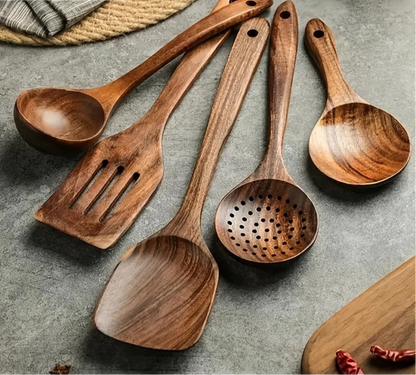 Natural teak wood kitchen set by Belro, includes cutting boards and utensils, arranged on a wooden countertop.