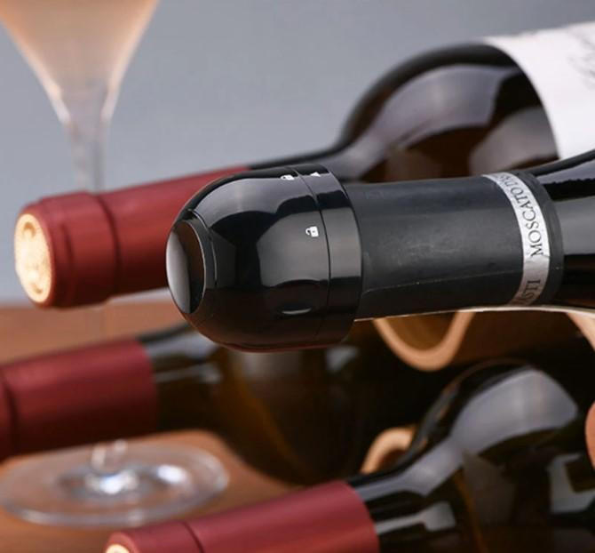 Belro silicone stopper sealing wine, beer, and champagne bottles in a kitchen setting, showcasing a flexible, airtight bottle stopper.