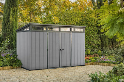 Casavibeo Keter Cortina 9x7 ft. green outdoor storage shed with grey artisan-style doors and heavy-duty floor.