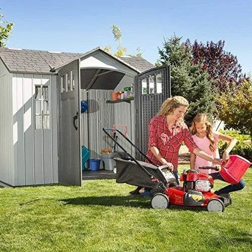 Casavibeo Lifetime 10x8 ft outdoor storage shed with double doors and windows, set in a backyard garden.