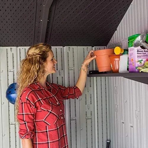 Casavibeo Lifetime 60243 10x8 ft outdoor storage shed with double doors and shingle roof, set in a backyard garden.