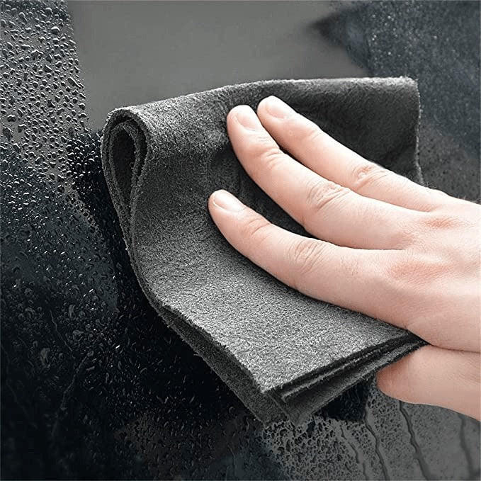 Belro Magic Cleaning Cloth draped over a T-shirt, showcasing its soft, absorbent fabric for cleaning clothing and surfaces.