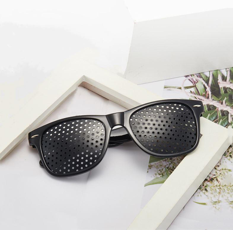 Belro anti-fatigue pinhole glasses with small lens holes designed to reduce eye strain, shown in a close-up image.