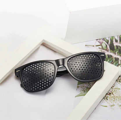 Belro anti-fatigue pinhole glasses with small lens holes designed to reduce eye strain, shown in a close-up image.