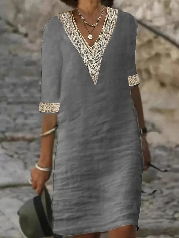 Elegant Belro half-sleeve dress with a flowing silhouette, featuring a fitted waist and stylish neckline for sophisticated wear.