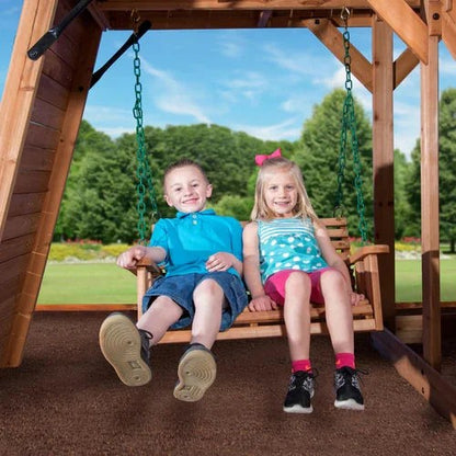 Casavibeo Backyard Discovery Caribbean Swing Set with porch, swings, and climbing features in a backyard setting.