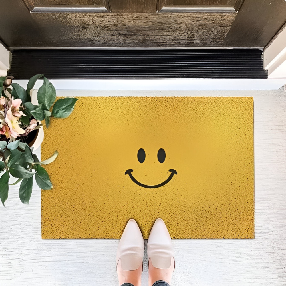 Cheeky smiley print doormat with non-slip PVC backing, quick-drying surface, measures 40x60cm, ideal for home entryways.