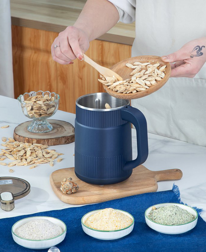 Belro home flour mill with stainless steel grinding chamber and hopper for fresh, ground flour in a kitchen setting.