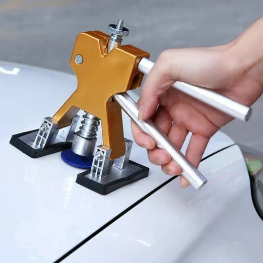 Belro car dent repair puller tool used for paintless dent removal, shown with the dent repair kit on a car surface.